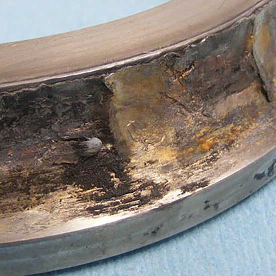 An angular contact bearing inner ring with material deposition from the balls following seizure